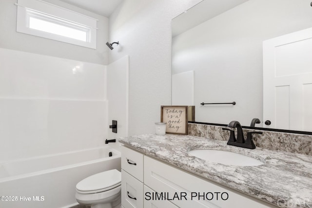 full bathroom featuring toilet, shower / washtub combination, and vanity