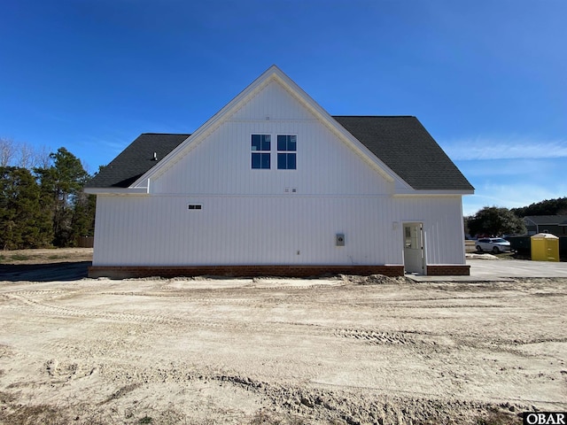 view of home's exterior with roof with shingles