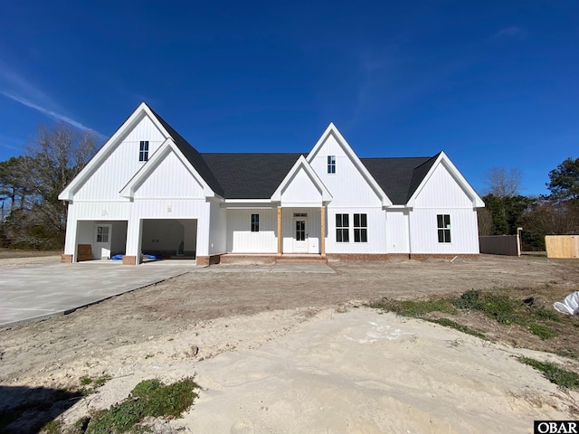 modern farmhouse style home with driveway and a garage