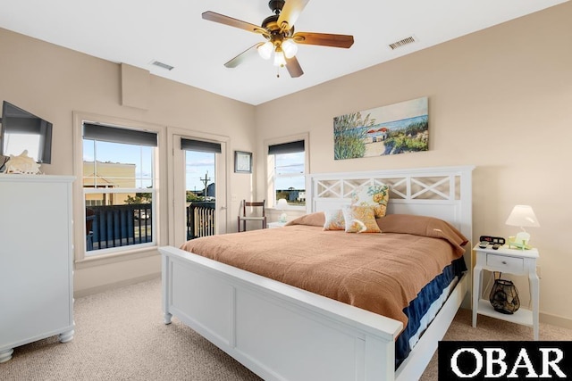 bedroom with access to exterior, light colored carpet, visible vents, and baseboards