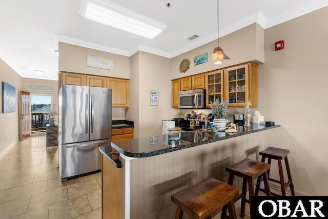 kitchen featuring visible vents, glass insert cabinets, brown cabinetry, appliances with stainless steel finishes, and a peninsula