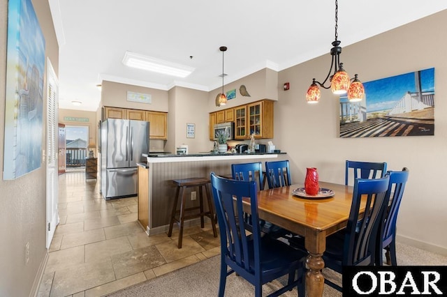 dining space featuring baseboards