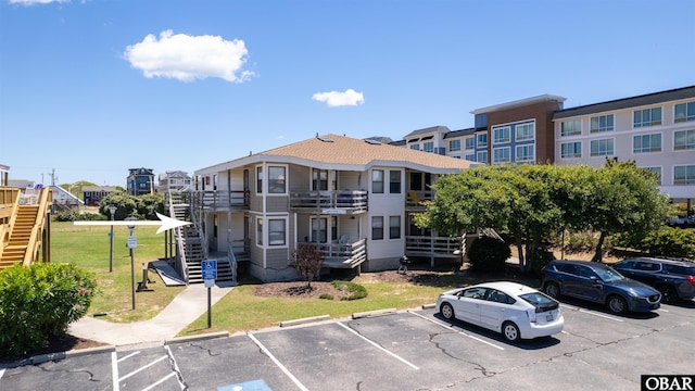 2009 Wrightsville Blvd Unit 4-B, Kill Devil Hills, NC 27948 - view of building exterior featuring uncovered parking and stairs