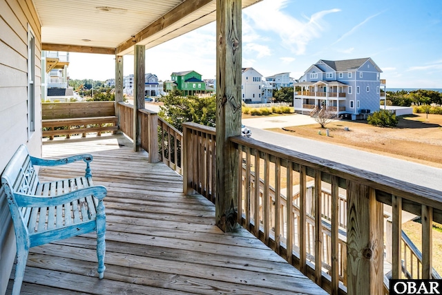 deck with a porch and a residential view