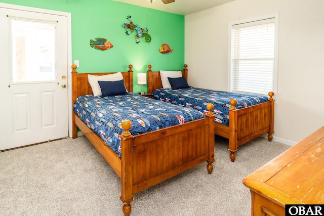 bedroom with baseboards and light colored carpet