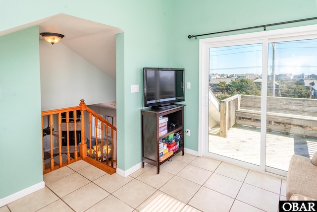 rec room featuring light tile patterned floors and baseboards