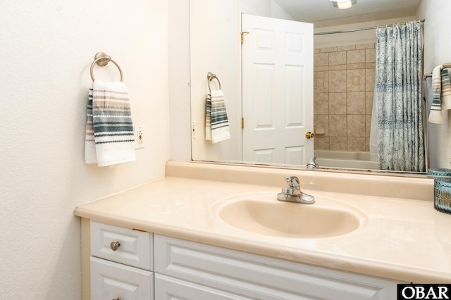 bathroom featuring shower / bathtub combination with curtain and vanity