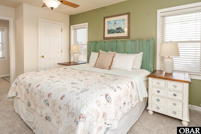 bedroom with light colored carpet, ceiling fan, and baseboards