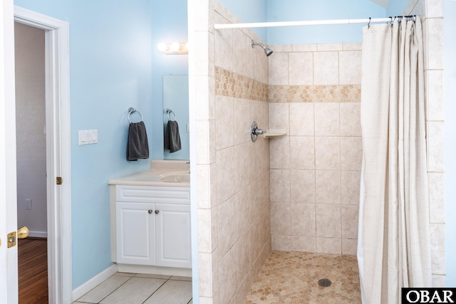 full bathroom featuring a stall shower, tile patterned flooring, and vanity