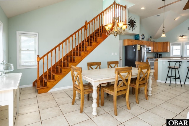 dining space featuring light tile patterned floors, stairs, baseboards, and a notable chandelier