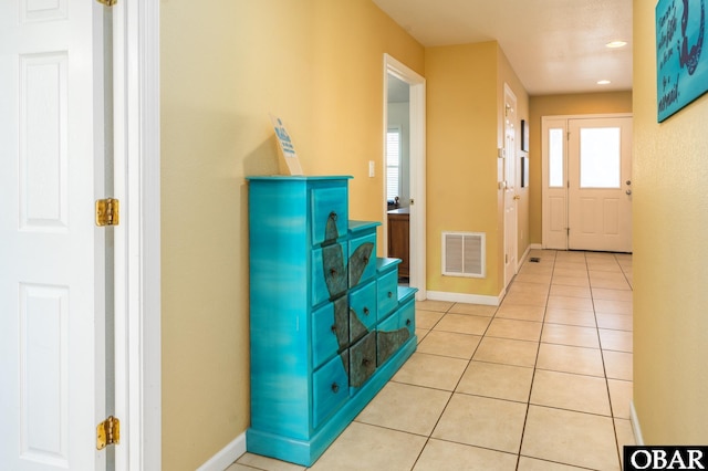 entryway featuring light tile patterned floors, visible vents, and baseboards