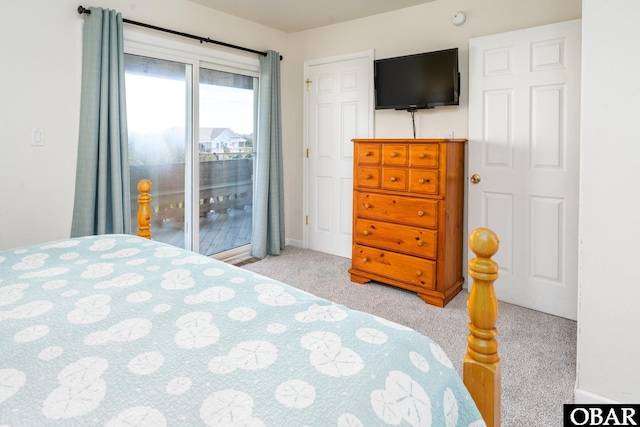 bedroom with access to outside and light colored carpet