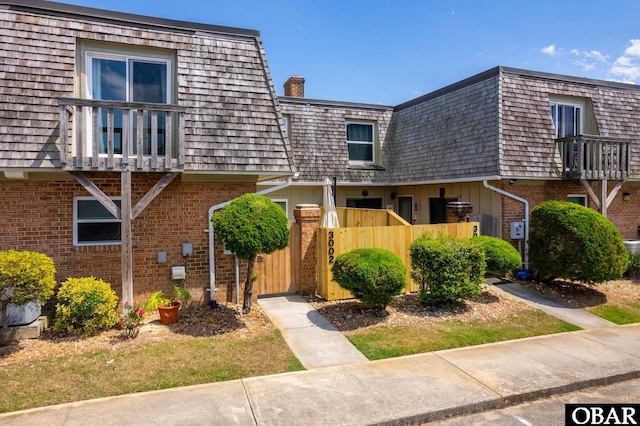 3002 Seahorse Ct Unit 3002, Kitty Hawk, NC 27949 - view of front of property with brick siding, mansard roof, and a chimney