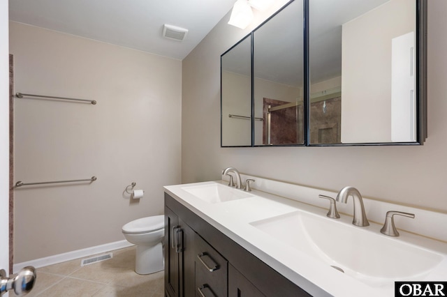 3002 Seahorse Ct Unit 3002, Kitty Hawk, NC 27949 - bathroom with toilet, baseboards, tile patterned flooring, a shower with door, and double vanity
