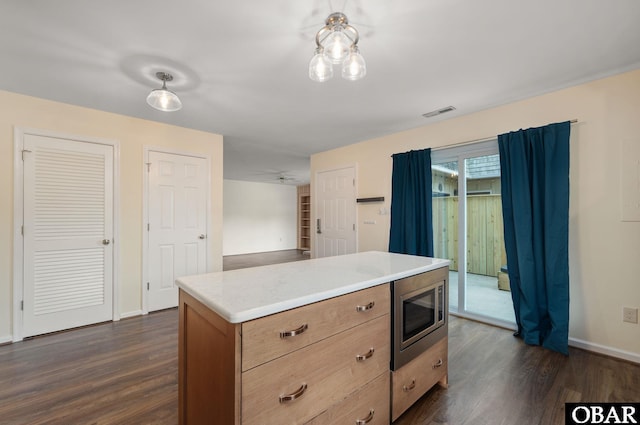 3002 Seahorse Ct Unit 3002, Kitty Hawk, NC 27949 - kitchen featuring stainless steel microwave, dark wood-style flooring, baseboards, and light countertops