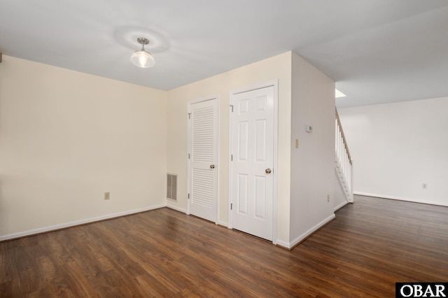 3002 Seahorse Ct Unit 3002, Kitty Hawk, NC 27949 - unfurnished room featuring dark wood-style floors, baseboards, and stairs