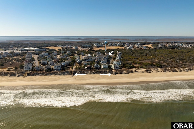 birds eye view of property featuring a water view, a residential view, and a view of the beach