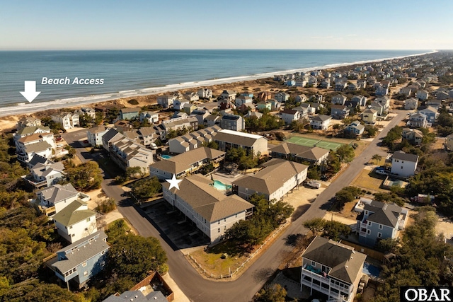 bird's eye view featuring a view of the beach, a water view, and a residential view