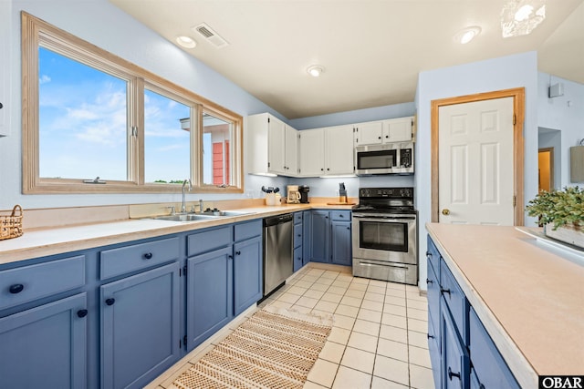 903 Windward Way Lot 15, Corolla, NC 27927 - kitchen with appliances with stainless steel finishes, a sink, blue cabinetry, and white cabinets