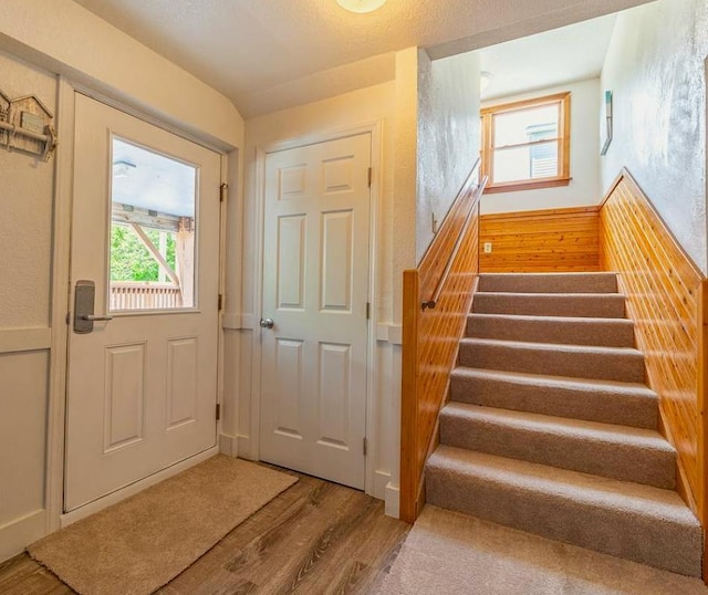 doorway to outside featuring stairway and wood finished floors