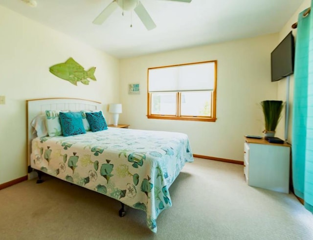 bedroom with carpet flooring, baseboards, and ceiling fan