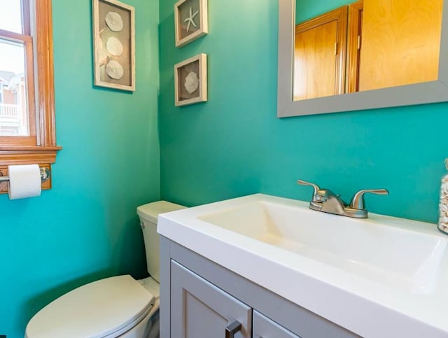 bathroom featuring toilet and vanity