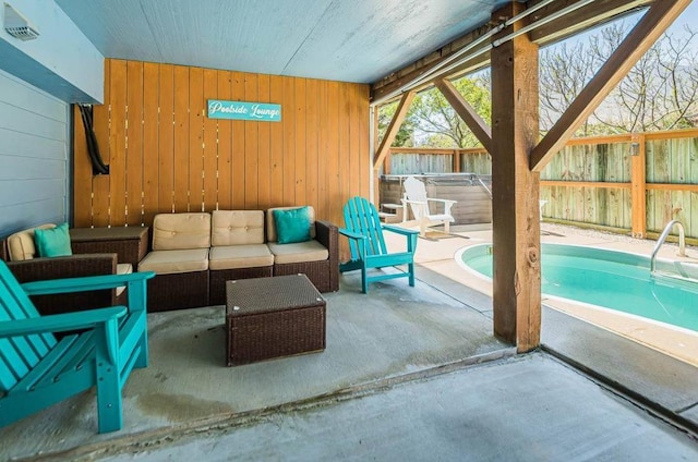 exterior space featuring a patio, fence, a fenced in pool, and an outdoor hangout area