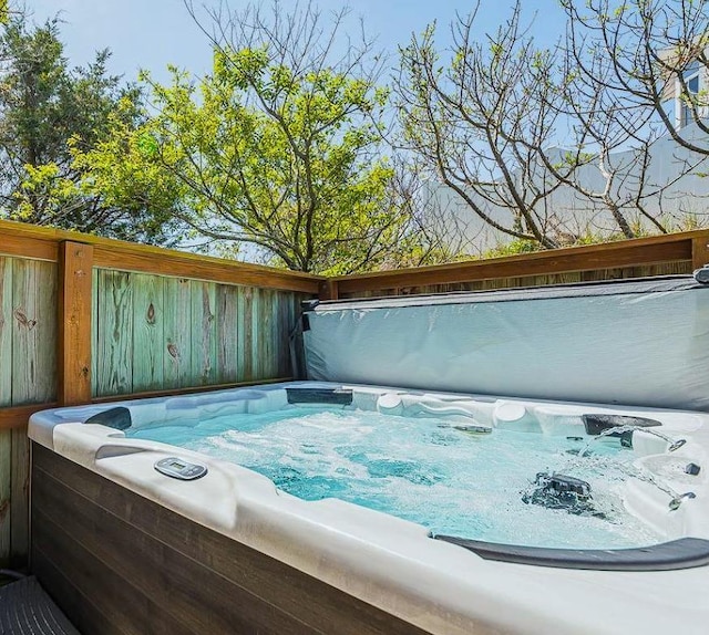 view of pool with a hot tub