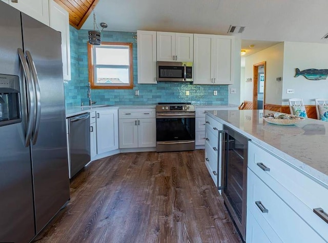 kitchen with visible vents, wine cooler, white cabinets, stainless steel appliances, and a sink