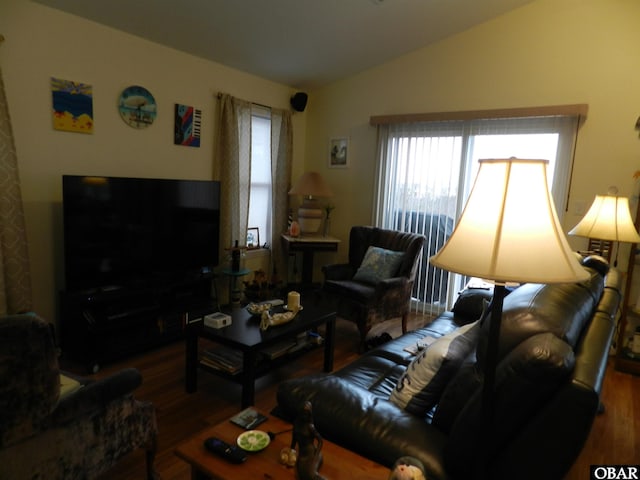 living area with vaulted ceiling and wood finished floors