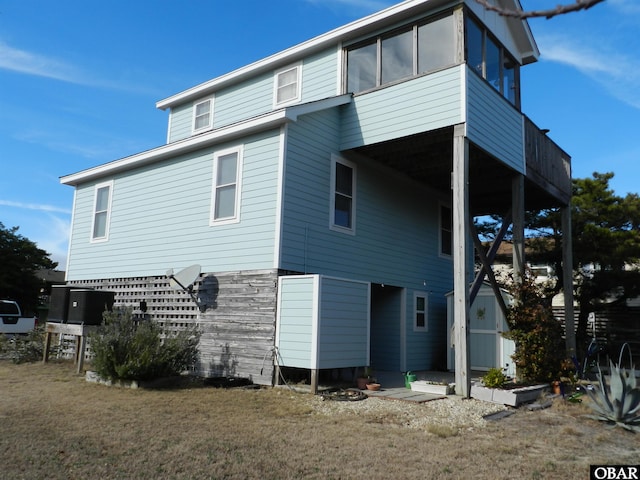 rear view of property with a lawn