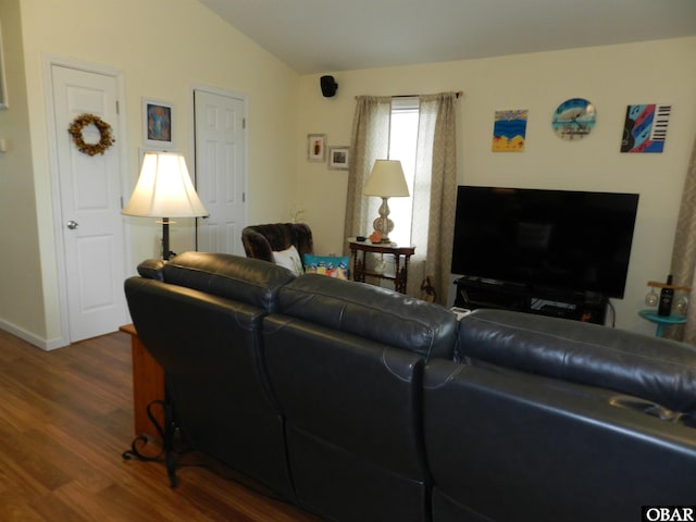 living room featuring lofted ceiling and wood finished floors