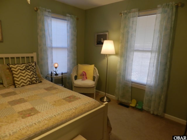 bedroom with carpet flooring and baseboards