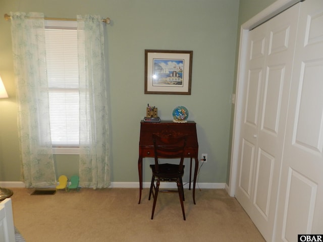 sitting room featuring light carpet, visible vents, and baseboards