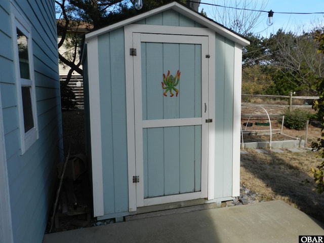 view of shed featuring fence