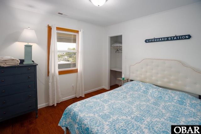 bedroom featuring dark wood-style floors and baseboards