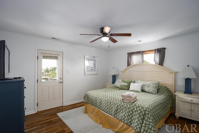 bedroom featuring dark wood-style flooring, multiple windows, visible vents, and baseboards