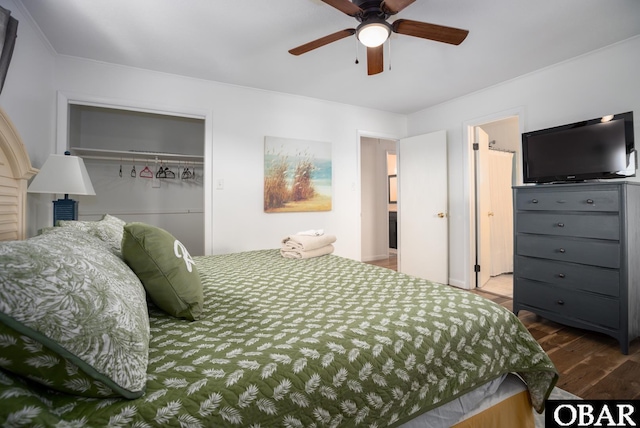 bedroom featuring dark wood-style floors, a closet, and a ceiling fan