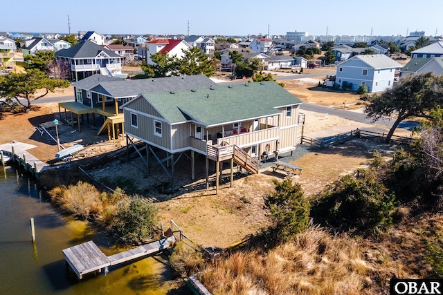 birds eye view of property with a water view and a residential view