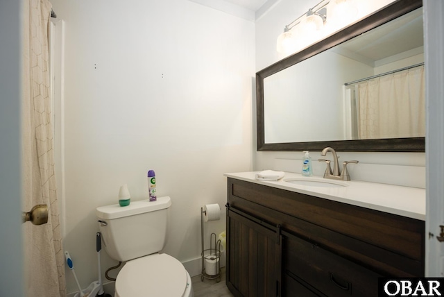 full bathroom with vanity, toilet, and baseboards