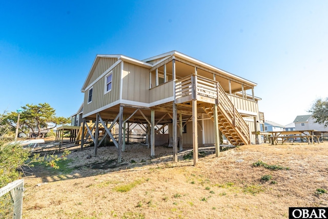 rear view of house featuring board and batten siding