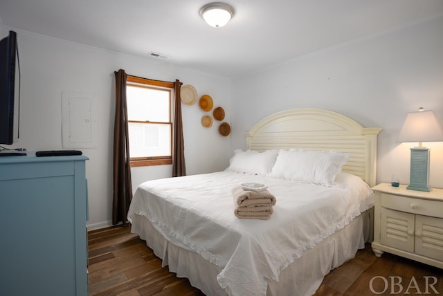 bedroom featuring dark wood finished floors and visible vents