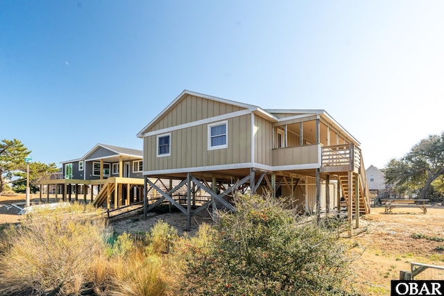 rear view of property featuring stairs