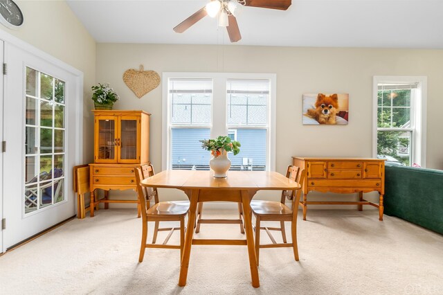 dining space featuring carpet and a ceiling fan