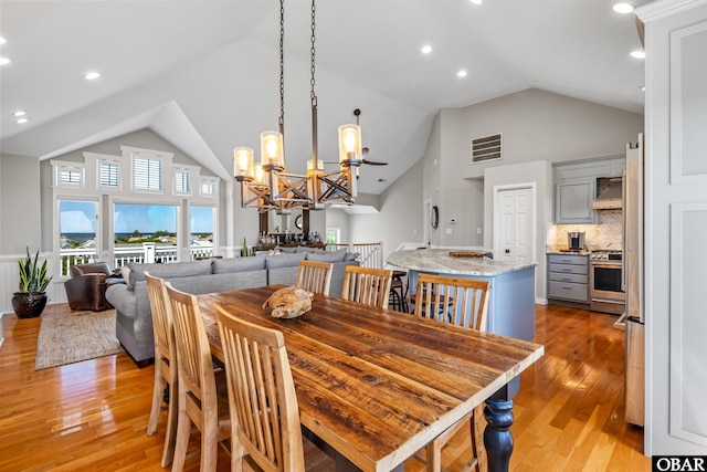4311 S Hesperides Dr Lot # 55, Nags Head, NC 27959 - dining space with high vaulted ceiling, light wood finished floors, a chandelier, and visible vents