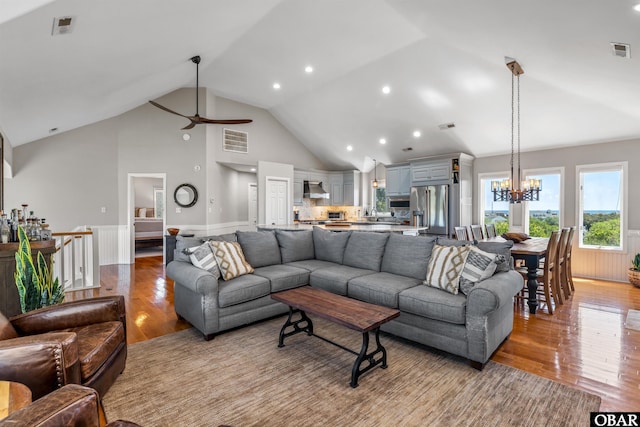 4311 S Hesperides Dr Lot # 55, Nags Head, NC 27959 - living area featuring visible vents, light wood-style flooring, ceiling fan with notable chandelier, and a wainscoted wall