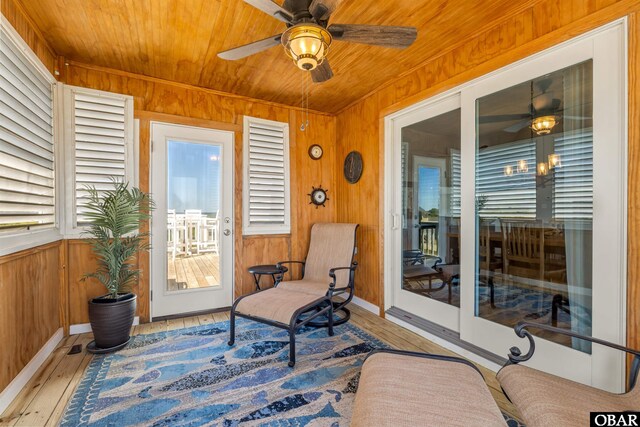 4311 S Hesperides Dr Lot # 55, Nags Head, NC 27959 - exterior space featuring a ceiling fan, wood walls, wooden ceiling, baseboards, and light wood finished floors