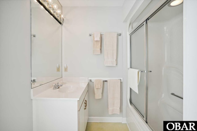 bathroom with shower / bath combination with glass door and vanity
