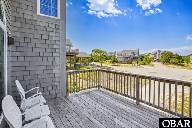 wooden terrace featuring a residential view