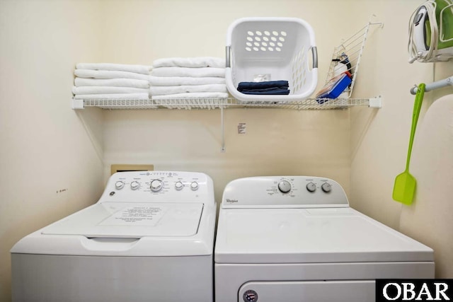 clothes washing area featuring independent washer and dryer and laundry area